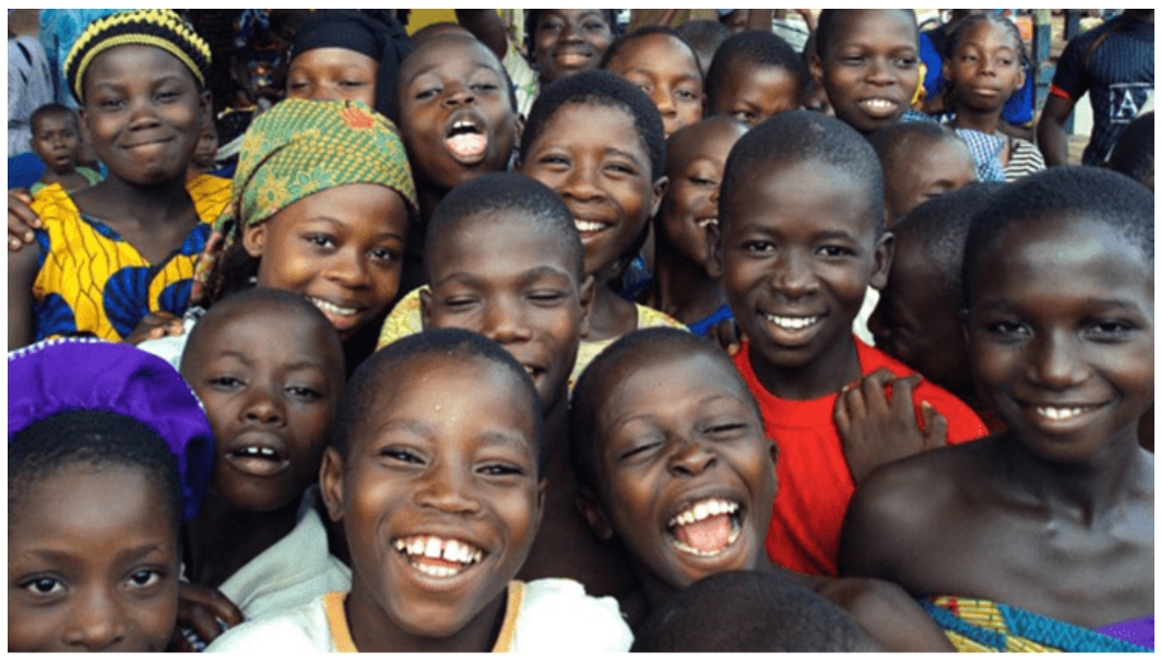 Children in Nigeria smiling and laughing together outdoors