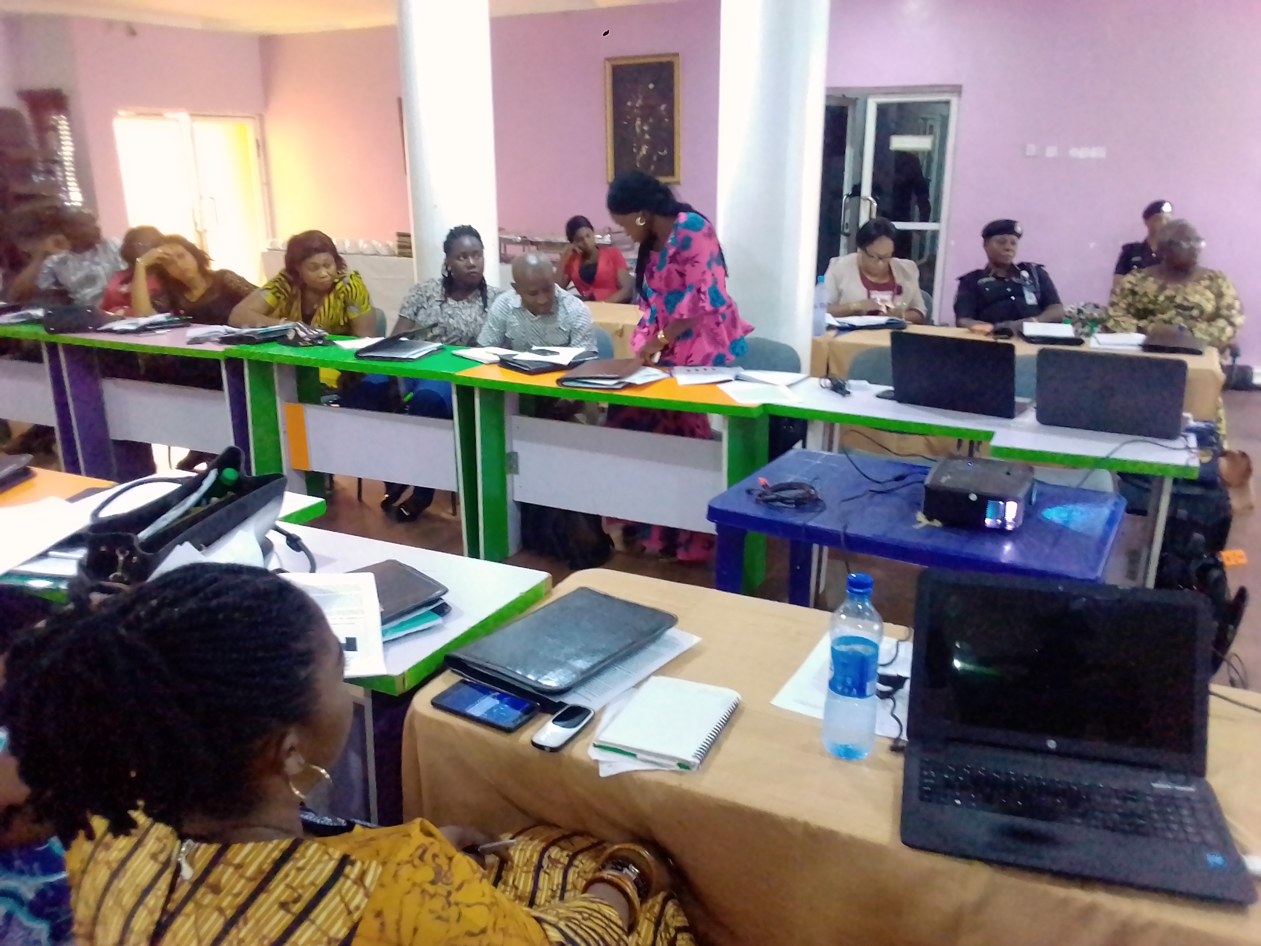 Workshop participants reviewing documents together while a facilitator offers guidance