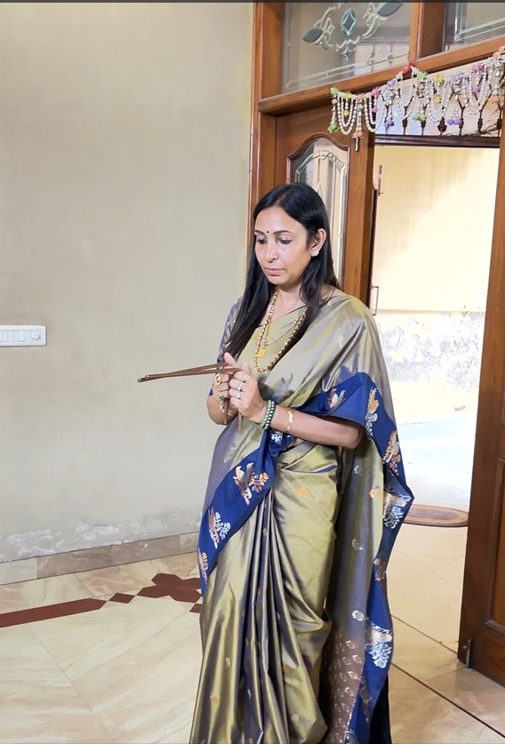 Acharya Swetta Garg holding assessment rods during an on-site Vastu consultation