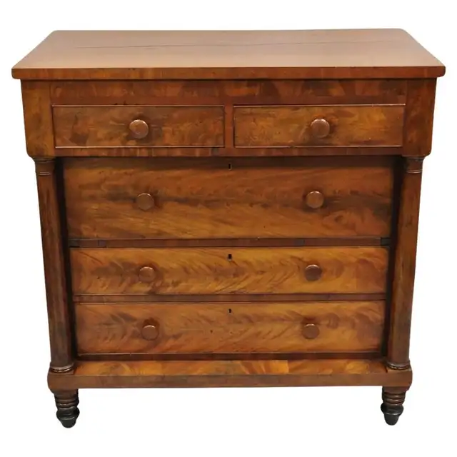 Warm figured-wood chest with two small drawers above three wide drawers, column sides and turned feet